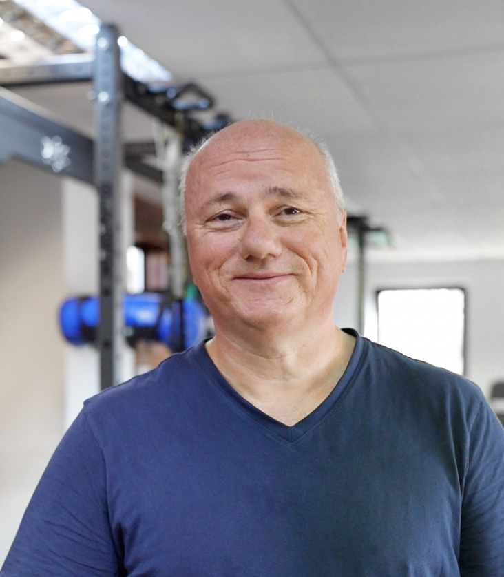Peter, a member at The Training Gyms in Hitchin, smiling after a personal training session, feeling strong and energised in his 60s.