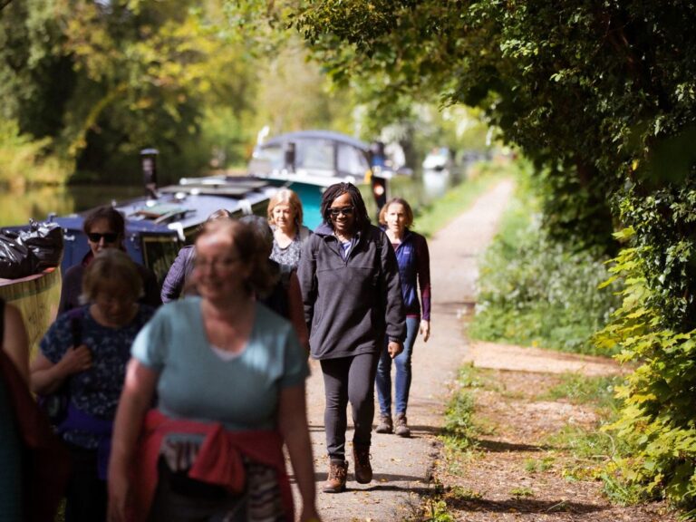 A group of women walking along the canal near Campbell Park, a popular wellness spot for personal training in Milton Keynes.